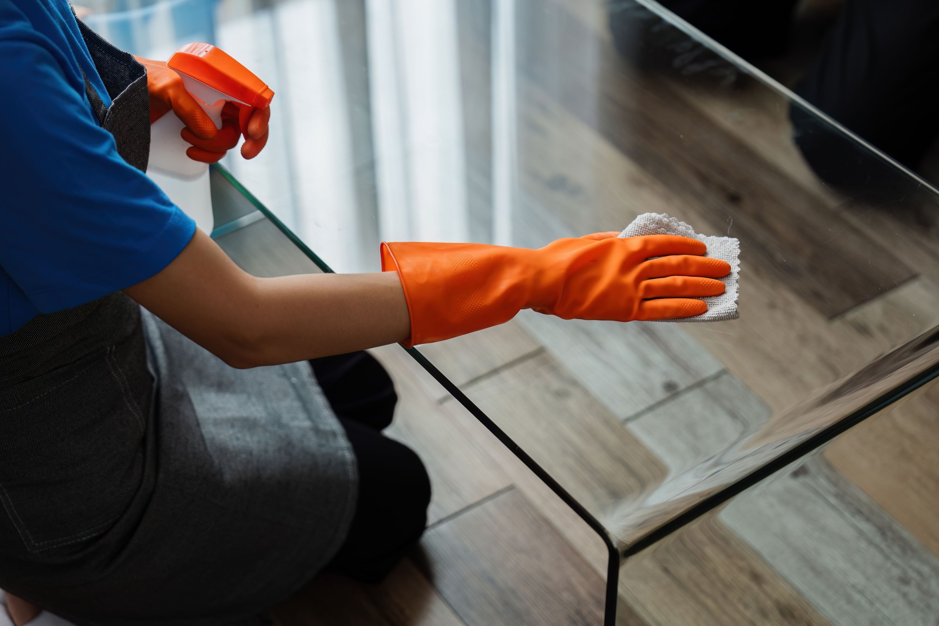 Housekeeping woman wiping the table in the living room House cleaning service concept